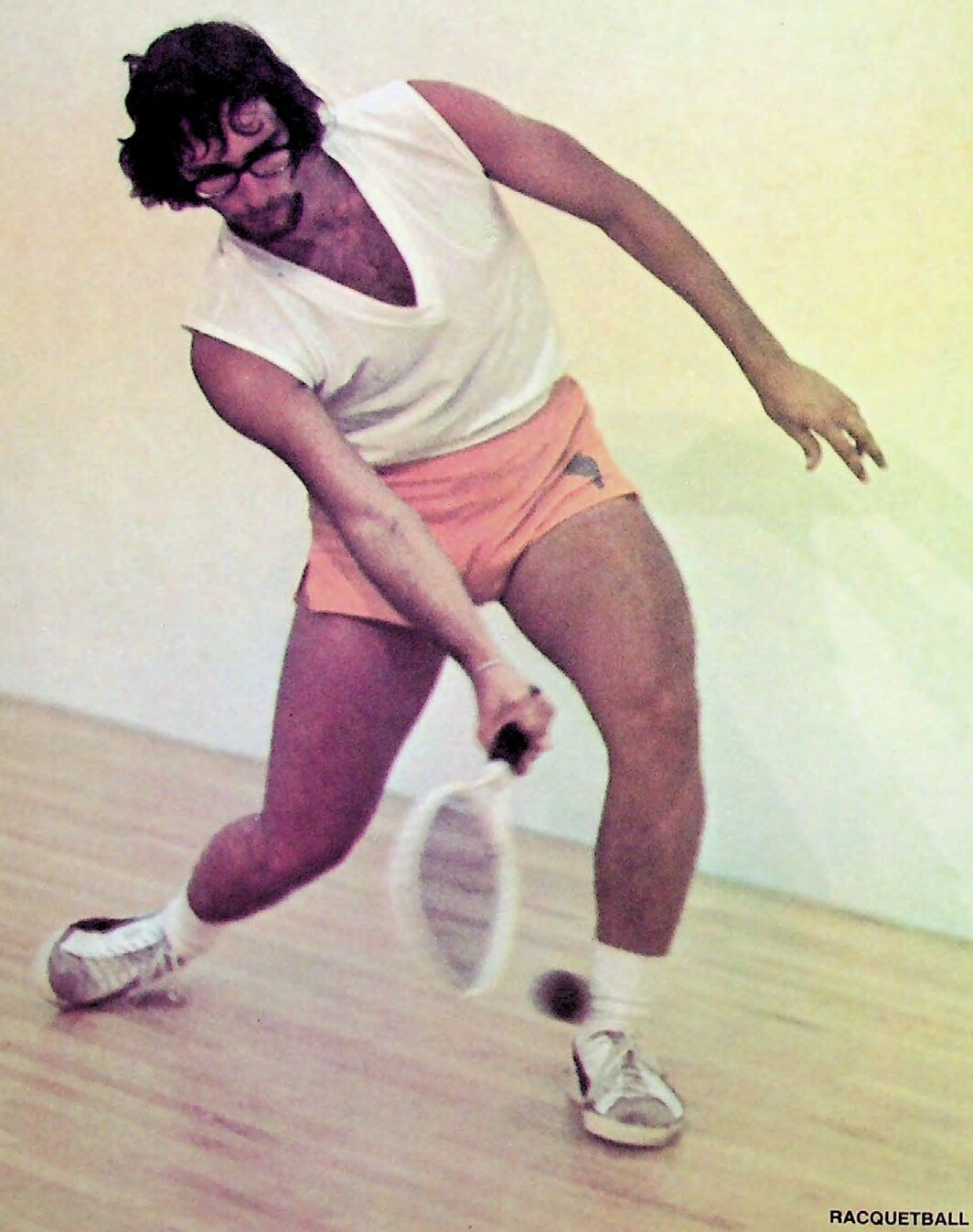Charlie Brumfield making a forehand swing on a racquetball court, photographed for National Racquetball (1973).